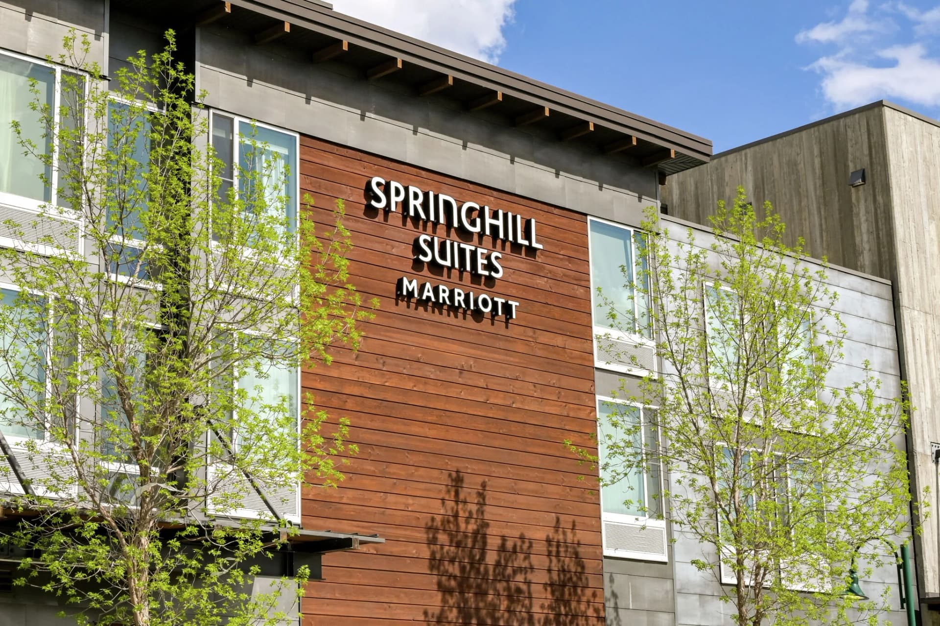 A SpringHill Suites by Marriott hotel exterior with the brand sign on a wood-clad facade
